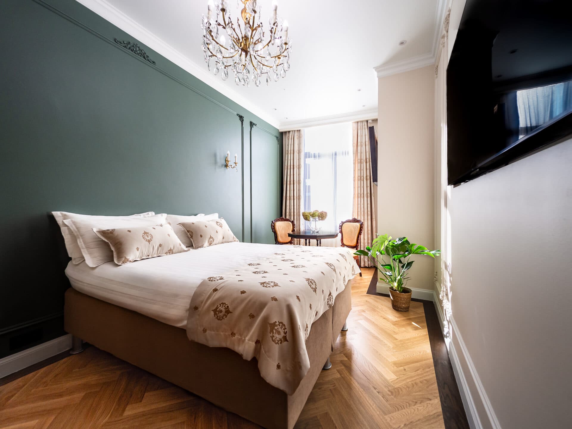 Superior Twin Room with forest green paneling and crystal chandelier