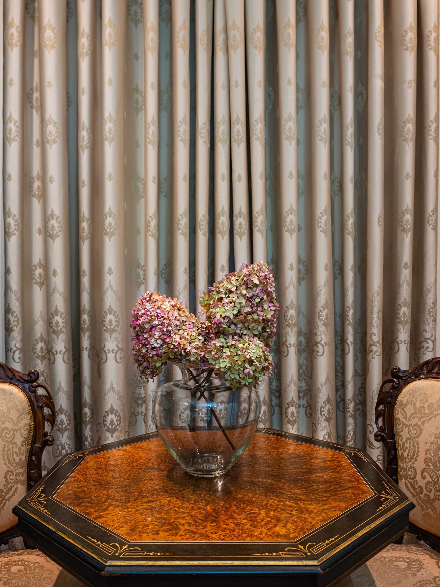 Antique seating area with hydrangeas in the Superior Twin Room